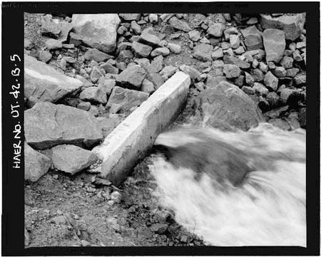 HAER photo of downstream outlet pipe and collar, looking west, July 1985