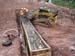 15-East Timothy Stabilization, pouring 3rd gabion basket using skidsteer for transporting cement