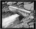 HAER photo of outlet pipe and concrete collar at Island Lake Dam, July 1985